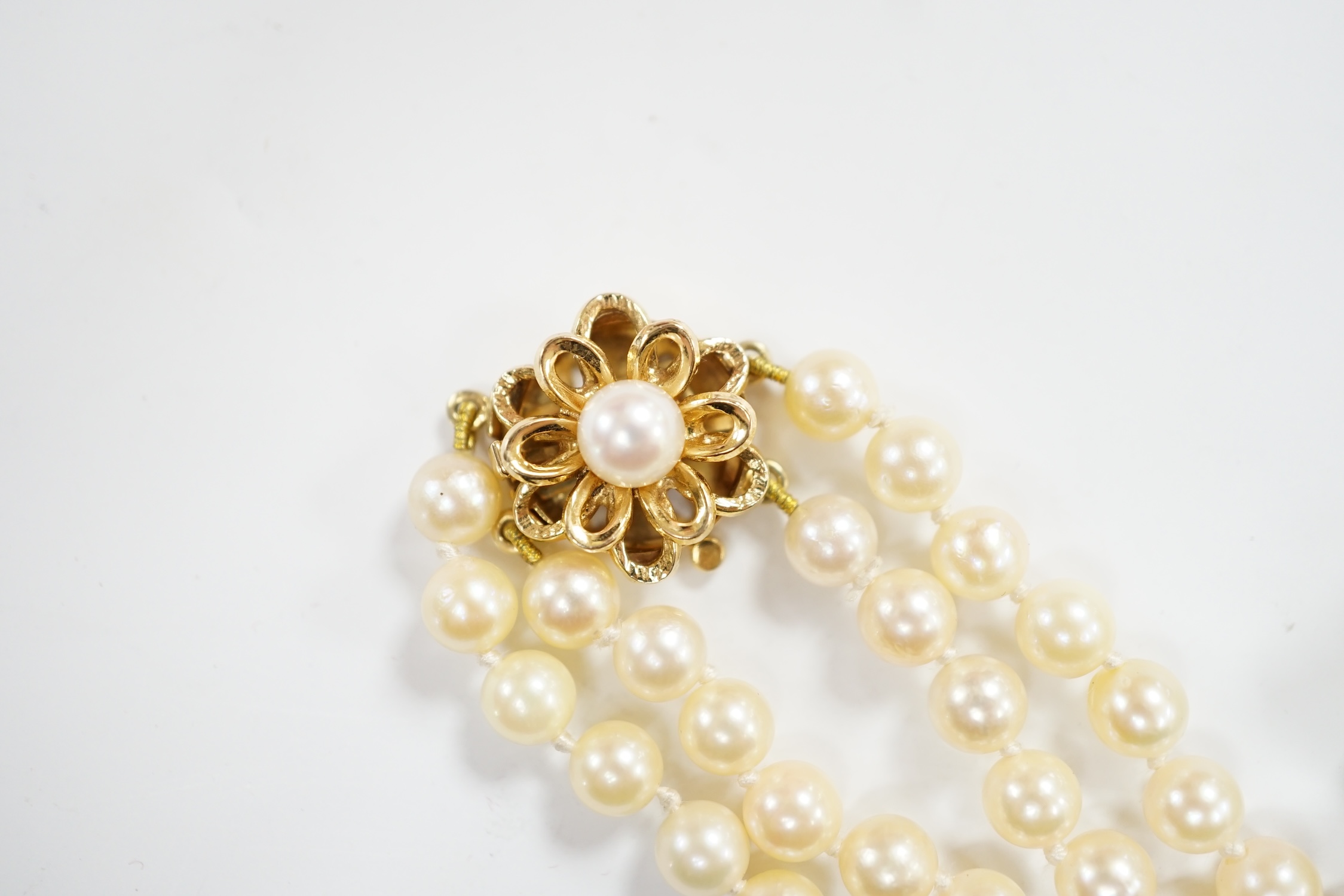 A cultured pearl cluster set bracelet, with seed pearl cluster set 9ct clasp, 16cm, and a similar double row choker necklace, with 9ct clasp, 38cm.